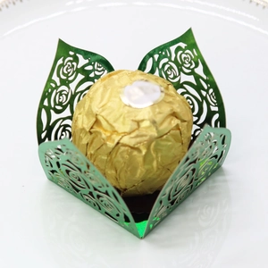 Detail of laser-cut hollow rose pattern in dark green with golden chocolate center