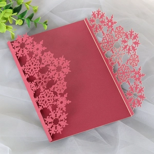 Detailed laser-cut burgundy snowflake greeting card with intricate holiday pattern design