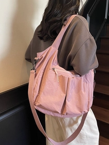 Pink large-capacity nylon tote bag with wide shoulder strap and functional front pockets