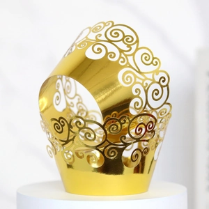 Close-up of golden hollowed-out cloud pattern cupcake liners with metallic finish