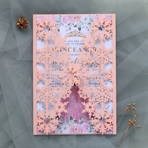 Laser-cut snowflake invitation with pink rose floral inner card on textured mesh