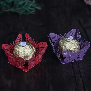 Close-up of laser-cut butterfly chocolate liners for wedding candy box decorations