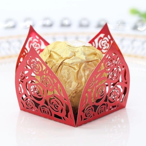 Intricate laser-cut red rose pattern wedding favor box with a gold foil chocolate ball