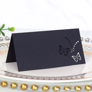 Detailed laser-cut butterfly design on elegant black kraft paper table place card