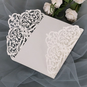 Detailed laser-cut floral pattern on off-white wedding invitation card with elegant lace