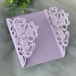 Detailed laser-cut floral pattern on purple trifold invitation cover for weddings