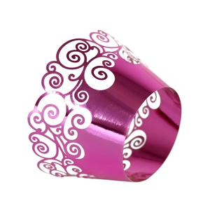 Close-up of metallic purple cupcake wrappers with laser-cut hollow swirl patterns