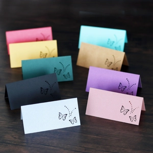 Close-up of laser-cut butterfly place cards in nine colors with a pearlescent finish