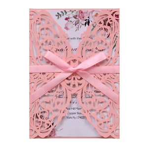Elegant laser-cut butterfly invitation card in pink with silk ribbon bow and floral detail