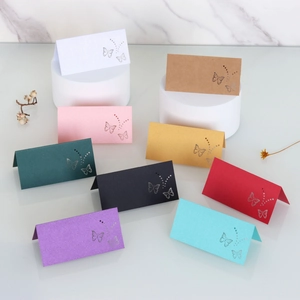 Detail view showing laser-cut butterfly kraft paper place cards in various vibrant colors