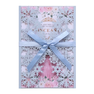 Elegant laser-cut snowflake invitation card with blue ribbon and floral inner sheet