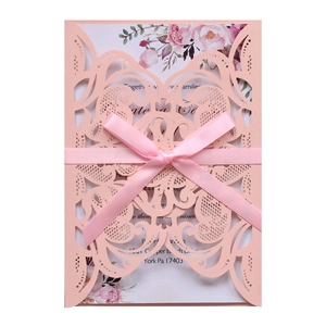 Elegant laser-cut lace wedding invitation in pink with silk ribbon and floral insert