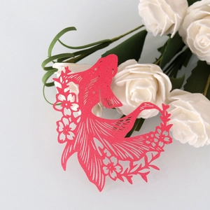 Detail of red hollow goldfish paper card with glitter texture for wine glass decoration