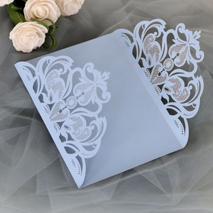 Intricate laser-cut floral details on a light blue three-fold wedding invitation card