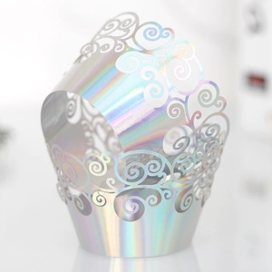 Detail of laser-cut iridescent cupcake wrapper with elegant scrollwork pattern
