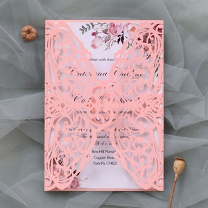 Detailed laser-cut butterfly wedding invitation with elegant floral insert on soft tulle