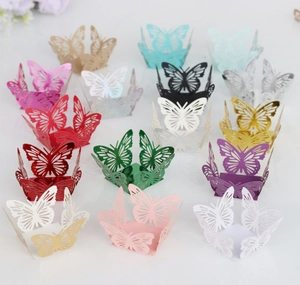 Macro detail of laser-cut butterfly cupcake wrappers in various metallic colors