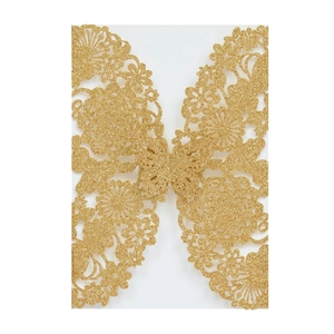 Macro shot of glittery gold laser-cut butterfly and floral wedding invitation cover