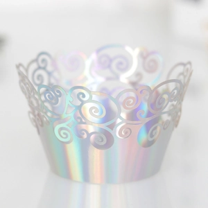 Macro detail of holographic silver cupcake wrapper with laser cut floral hollow design