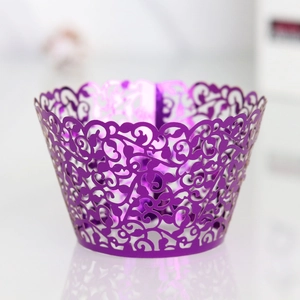 Detailed laser-cut vine patterns on dark purple metallic cupcake wrapper with reflections