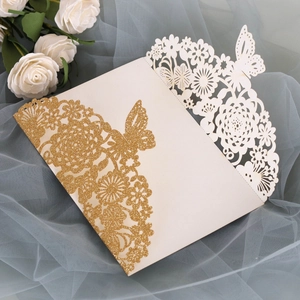 Detailed laser-cut floral wedding invitation cover with gold glitter accents