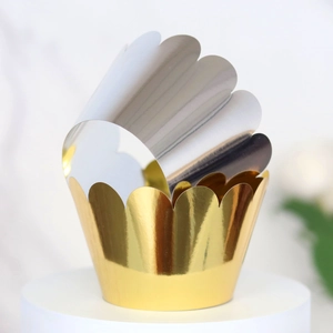 Macro detail of gold and silver cupcake wrappers with metallic mirror finish and wavy edges