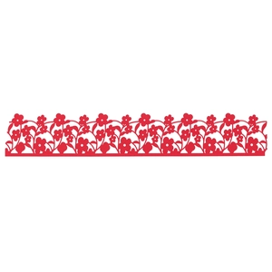 Detail of red laser-cut floral cake wrapper with intricate flower and vine hollow patterns