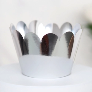 Close-up of laser-cut silver mirror cupcake wrappers with elegant wavy scalloped edges