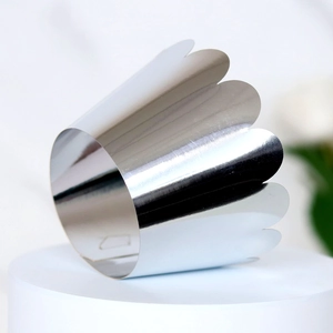 Detailed macro view of silver mirror finish cupcake wrapper with laser-cut wave edge