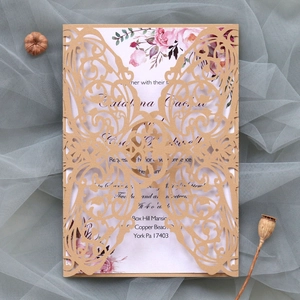 Detailed laser cut kraft paper wedding invitation with floral printed card on blue tulle