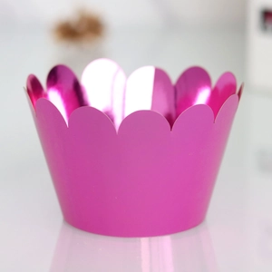 Macro shot of rose pink metallic cupcake wrapper featuring elegant scalloped laser-cut edges