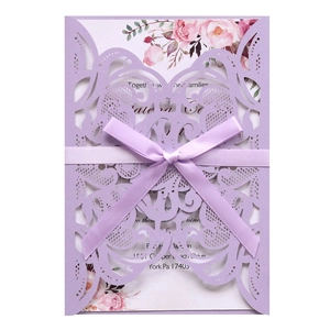 Elegant laser-cut purple wedding invitation with silk bow and floral inner card