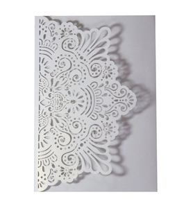 Laser-cut white pearl paper wedding invitation with intricate mandala lace pattern