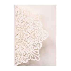 Detailed laser cut mandala patterns on ivory white wedding invitation card cover