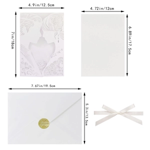 Detail of laser-cut wedding invitation with couple silhouette and golden seal