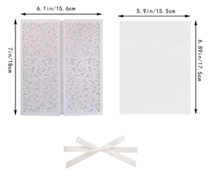 Detailed view of white laser-cut rose wedding invitation with bow and size dimensions