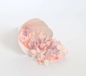 Detail of colorful dried hydrangea petals in a kraft paper cone for wedding toss