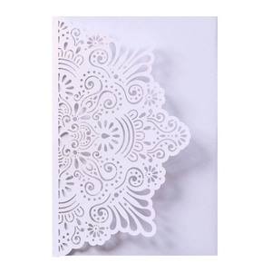 Exquisite laser cut wedding invitation card with intricate white floral mandala patterns