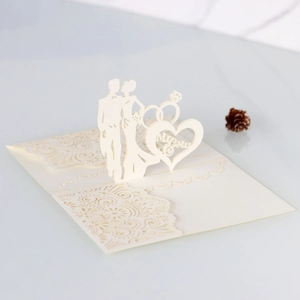Detail of 3D laser-cut wedding invitation with Mr & Mrs silhouette and lace hollow pattern