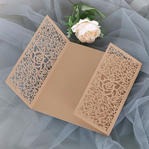 Detail of laser-cut rose floral hollow design on brown kraft paper wedding invitation cover