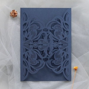 Detailed laser cut baroque vine patterns on a dark blue pearlescent paper card