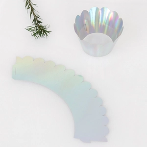 Detailed view of iridescent silver crown cupcake wrappers with laser cut wave edges