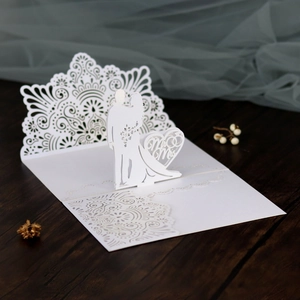 Detailed laser-cut hollow 3D wedding invitation featuring Mr & Mrs silhouettes on wood