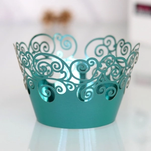 Detailed laser-cut teal cupcake wrappers featuring elegant hollow scroll patterns