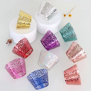 Close-up of laser cut cupcake wrappers with elegant vine patterns in multiple metallic colors
