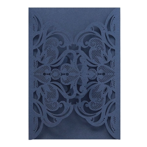 Detailed laser-cut floral pattern on navy blue invitation card cover for weddings