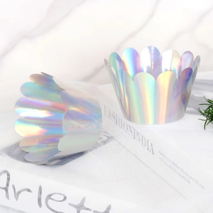 Close-up of laser holographic silver crown cupcake wrappers with wavy petal edge design
