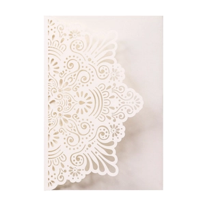 Detailed laser-cut mandala lace pattern on cream wedding invitation card cover