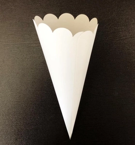 Detail of white paper cone with scalloped edges for wedding flower petals and confetti