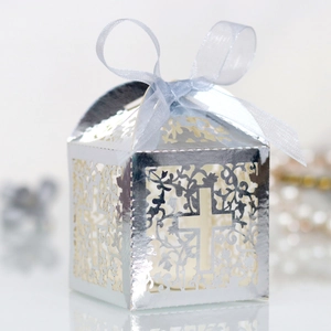 Detailed laser-cut silver candy box with floral cross design and light blue ribbon
